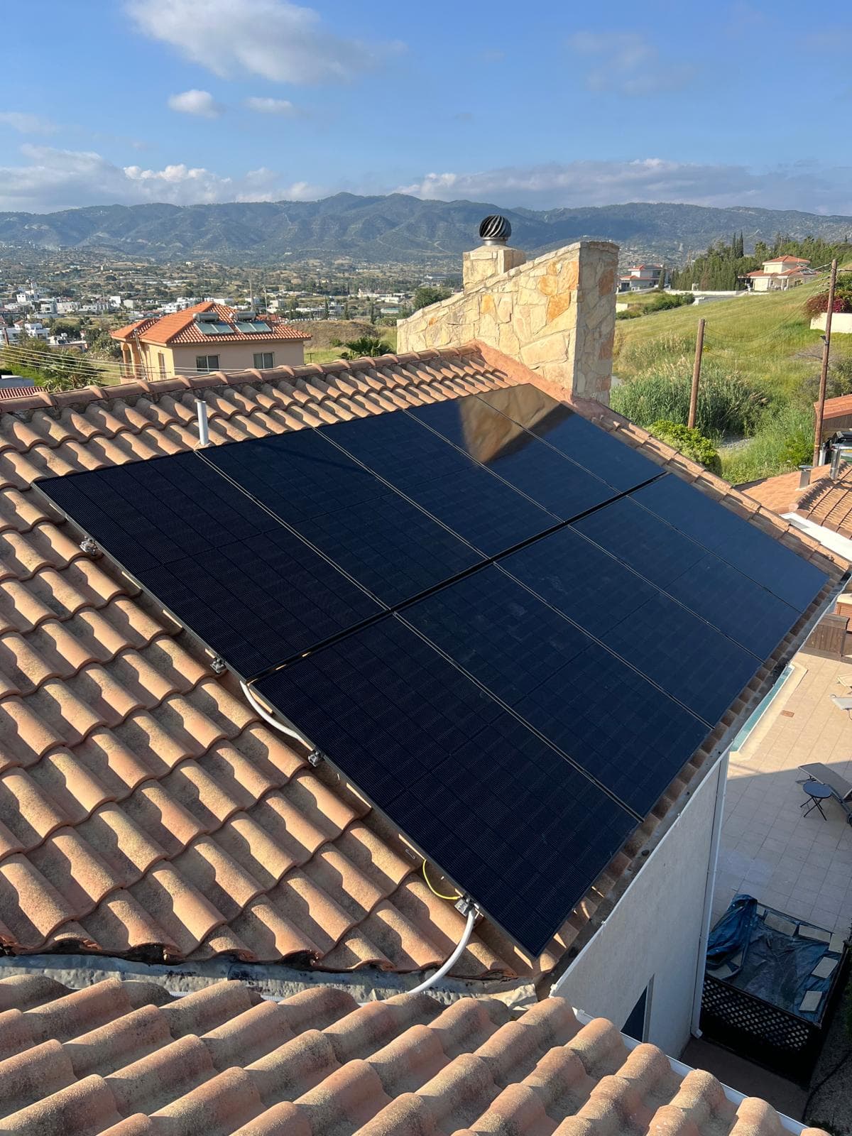 New-generation photovoltaic panels installed on a Cyprus rooftop with mountain views