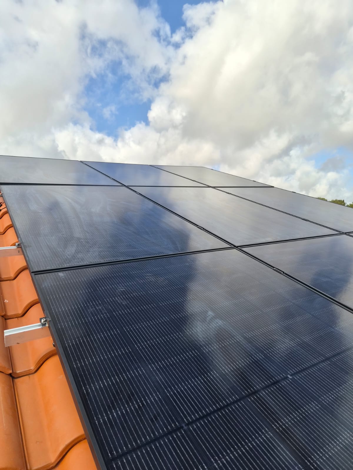 Close-up of new monocrystalline photovoltaic panels on a tiled Cyprus roof